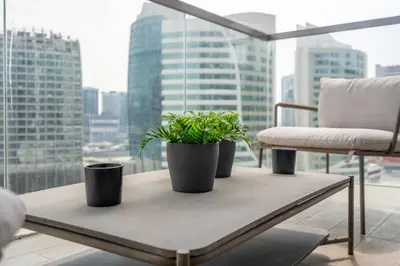 a table with three potted plants on it in front of a window at GuestReady - Luxurious Accents near Burj Khalifa in Dubai