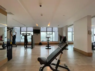 a gym with treadmills and exercise equipment in a building at GuestReady - Luxurious Accents near Burj Khalifa in Dubai