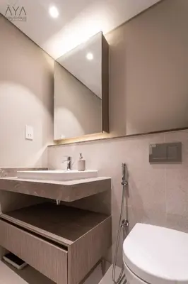 a bathroom with a sink and a toilet and a mirror at Elegant Luxury Apartment with Stunning Lake Views in Dubai Creek Harbour By ĀYA Boutique in Dubai