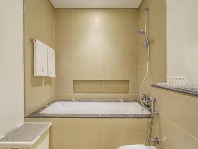 a bathroom with a tub and a toilet at Bright and Splendid 1BR with Marina View in Dubai