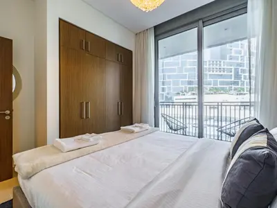 a bedroom with a large bed with a large window at Bright and Splendid 1BR with Marina View in Dubai