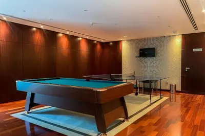 a room with a pool table and a table at Frank Porter - The Jwls T2 in Dubai