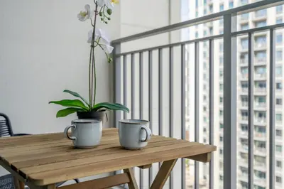 two mugs on a wooden table with a plant at GuestReady - Chic accents in Dubai Hills in Dubai