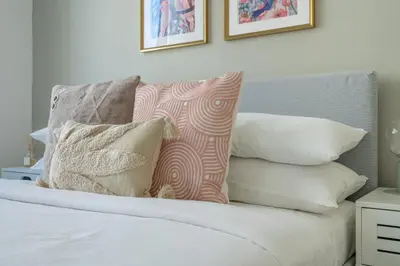 a bedroom with a bed with pillows on it at GuestReady - Chic accents in Dubai Hills in Dubai