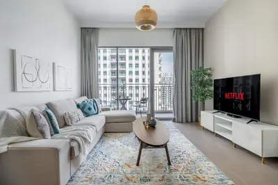a living room with a couch and a tv at GuestReady - Chic accents in Dubai Hills in Dubai