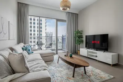 a living room with a couch and a tv at GuestReady - Chic accents in Dubai Hills in Dubai