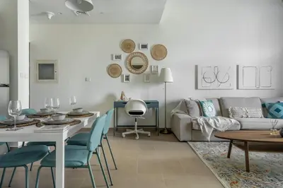 a living room with a table and a couch at GuestReady - Chic accents in Dubai Hills in Dubai