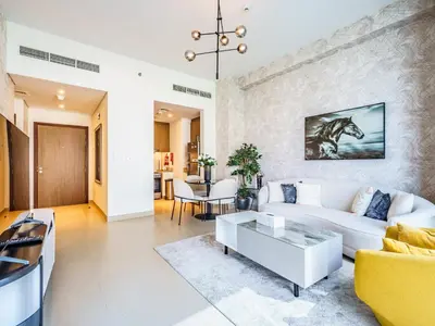 a living room with a white couch and a table at Marvelous 1BR with Beautiful Marina View in Dubai