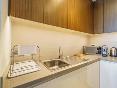 a kitchen with a sink and a microwave at Marvelous 1BR with Beautiful Marina View in Dubai
