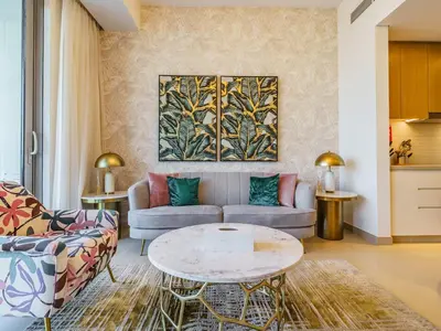 a living room with a couch and a table at Gorgeous 1 BR with Private Terrace - Marina View in Dubai