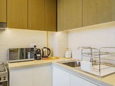 a kitchen with a sink and a microwave at Gorgeous 1 BR with Private Terrace - Marina View in Dubai