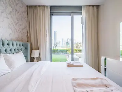 a bedroom with a bed and a large window at Gorgeous 1 BR with Private Terrace - Marina View in Dubai