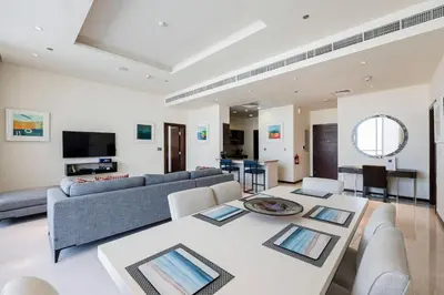 a living room with a couch and a table at 2 BD Tiara Palm Views, Beach & Pool, Amazing views of the Palm in Dubai