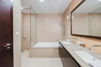 a bathroom with a tub and a sink and a shower at 2 BD Tiara Palm Views, Beach & Pool, Amazing views of the Palm in Dubai