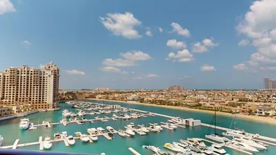 a marina filled with lots of boats in the water at 2 BD Tiara Palm Views, Beach & Pool, Amazing views of the Palm in Dubai