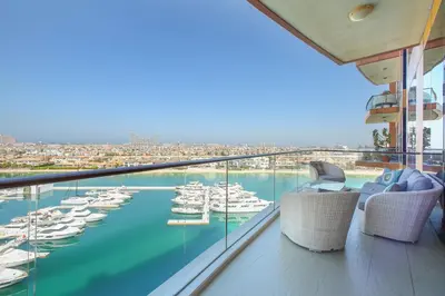 a balcony with a view of a harbor with boats at 2 BD Tiara Palm Views, Beach & Pool, Amazing views of the Palm in Dubai