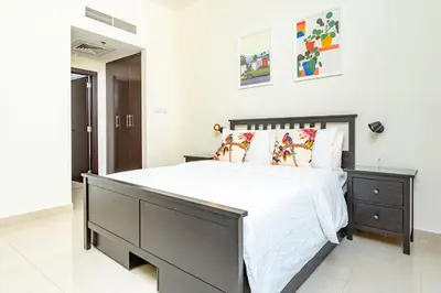 a bedroom with a large bed with white sheets and pillows at Captivating Arabian Sea & Burj Khalifa Views in Dubai
