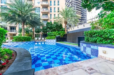 a swimming pool with blue tiles in a building at Captivating Arabian Sea & Burj Khalifa Views in Dubai