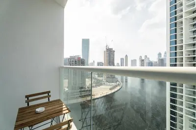 a balcony with a bench and a view of a city at ALiving Stylish Studio with Balcony I Partial Burj Khalifa View I DAMAC Maison Prive B-1315 in Dubai