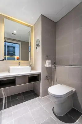 a bathroom with a sink and a toilet and a tub at ALiving Stylish Studio with Balcony I Partial Burj Khalifa View I DAMAC Maison Prive B-1315 in Dubai
