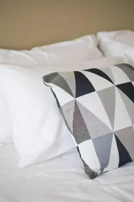 a pillow sitting on top of a white bed at Palm Tower St. Regis Amazing view high-end Studio in Dubai
