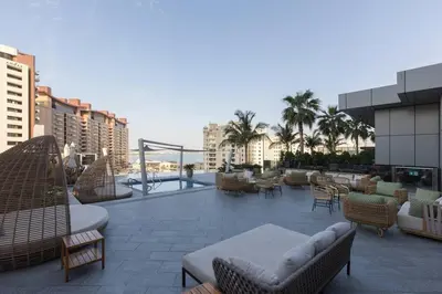 a patio with chairs and tables on a building at Palm Tower St. Regis Amazing view high-end Studio in Dubai