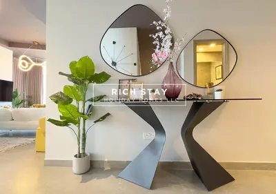 a dressing table with two mirrors on a wall at Grande 3BR in Stella Maris, Sea View, Dubai Marina in Dubai