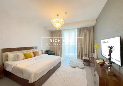 a bedroom with a large bed and a flat screen tv at Grande 3BR in Stella Maris, Sea View, Dubai Marina in Dubai