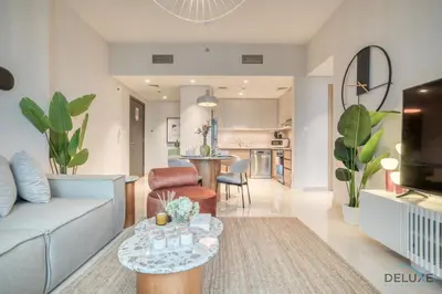 a living room with a couch and a table at Elegant 1BR at Harbour Views Tower 1 by Deluxe Holiday Homes in Dubai