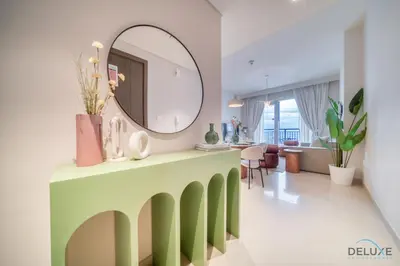 a living room with a mirror on top of a table at Elegant 1BR at Harbour Views Tower 1 by Deluxe Holiday Homes in Dubai