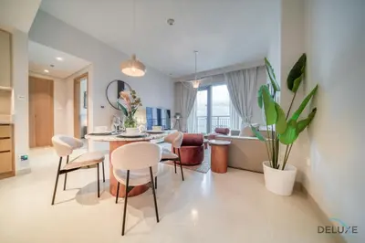 a kitchen and living room with a table and chairs at Elegant 1BR at Harbour Views Tower 1 by Deluxe Holiday Homes in Dubai