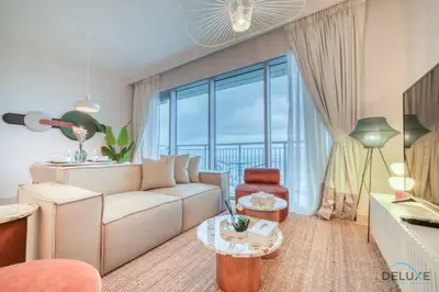 a living room with a couch and a large window at Alluring 1BR at Harbour Views Tower 1 by Deluxe Holiday Homes in Dubai