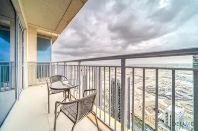 a balcony with a table and chairs and a view of the city at Alluring 1BR at Harbour Views Tower 1 by Deluxe Holiday Homes in Dubai