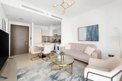 a living room with a couch and a table at Perfect 1 BR for Family Stay - Close to Downtown in Dubai