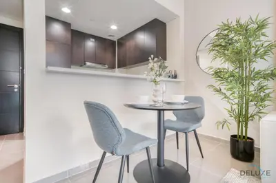 a dining room with a table and two chairs at Soothing 1BR at Merano Business Bay by Deluxe Holiday Homes in Dubai
