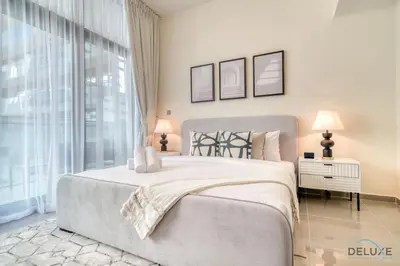 a bedroom with a large bed and a large window at Soothing 1BR at Merano Business Bay by Deluxe Holiday Homes in Dubai