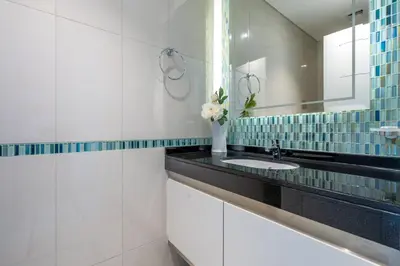 a bathroom with a sink and a mirror at GuestReady - Sweet Paradise near Marina Walk in Dubai