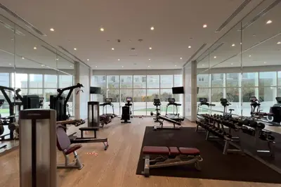 a gym with a lot of treadmills and machines at GuestReady - Sweet Paradise near Marina Walk in Dubai