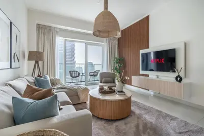 a living room with a couch and a tv at GuestReady - Sweet Paradise near Marina Walk in Dubai