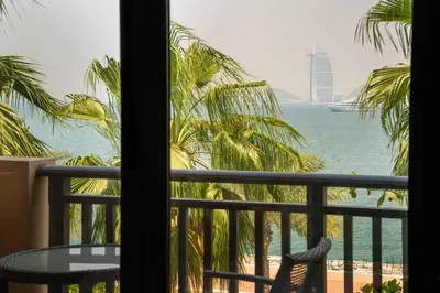 a view of the ocean from a hotel room window at Luxury Anantara Res - Sea & Burj AlArab View in Dubai