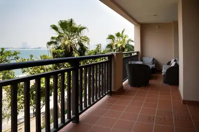 a balcony with a view of the ocean at Luxury Anantara Res - Sea & Burj AlArab View in Dubai