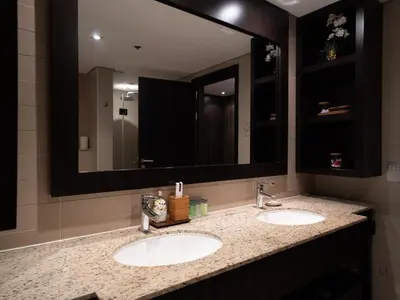 a bathroom with two sinks and a large mirror at Luxury Anantara Res - Sea & Burj AlArab View in Dubai