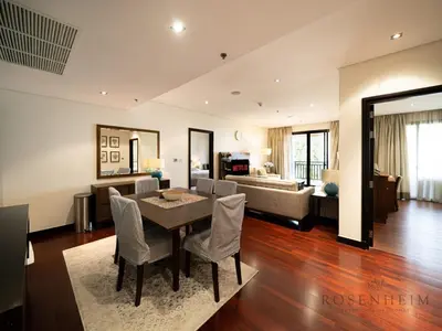 a living room with a dining table and a couch at Luxury Anantara Res - Sea & Burj AlArab View in Dubai