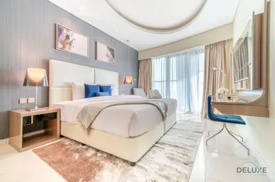 a bedroom with a large bed and a large window at Polished 3BR at DAMAC Towers by Paramount A Business Bay by Deluxe Holiday Homes in Dubai