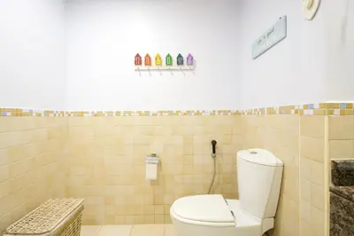 a bathroom with a toilet in a tiled wall at Charming spacious studio apartment in the heart of JBR By SWEET HOMES in Dubai