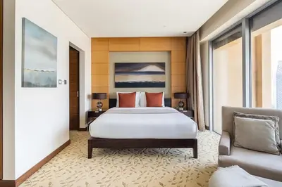 a bedroom with a large bed and a couch at Frank Porter - Emaar Residences Fashion Avenue in Dubai