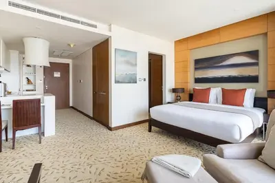 a hotel room with a bed and a desk at Frank Porter - Emaar Residences Fashion Avenue in Dubai
