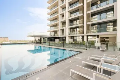 a swimming pool in front of a building at Luxurious 1-bedroom apartment in Dubai Hills in Dubai