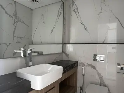 a bathroom with a white sink and a mirror at Luxurious 1-bedroom apartment in Dubai Hills in Dubai
