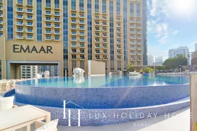 a large swimming pool in front of a building at LUX The JW Marina Suite in Dubai